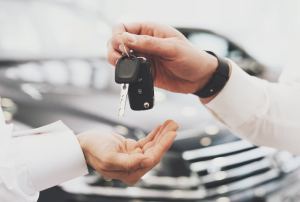 A person being handed a new set of car keys at a dealership near Beloit, Wisconsin